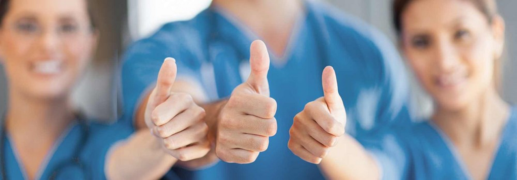 Three cleaning service technicians in blue uniforms giving thumbs up, symbolizing customer satisfaction and quality service guarantee from Wiz Team Inc.