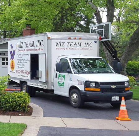 Wiz Team, Inc. cleaning truck parked in residential area, showcasing eco-friendly cleaning services for carpets, upholstery, and air ducts.
