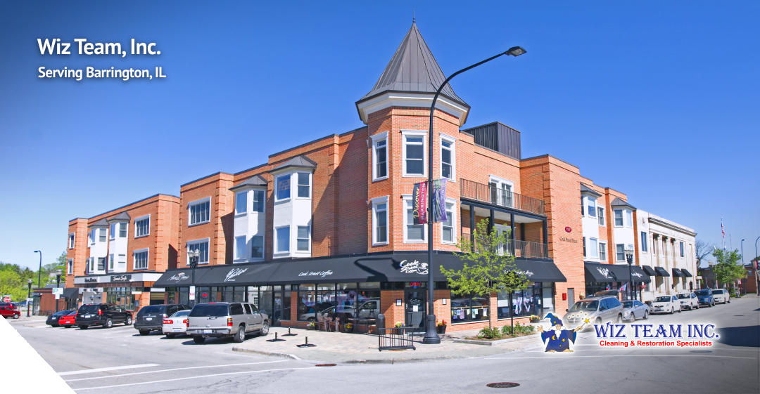 Wiz Team, Inc. building in Barrington, IL, showcasing a vibrant community atmosphere with shops and outdoor seating, emphasizing local cleaning services.