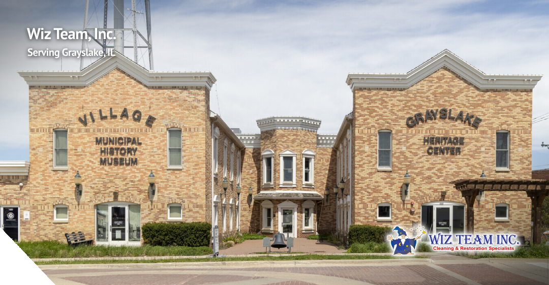 Grayslake Heritage Center and Municipal History Museum building with Wiz Team, Inc. logo, representing professional cleaning services in Grayslake, IL.
