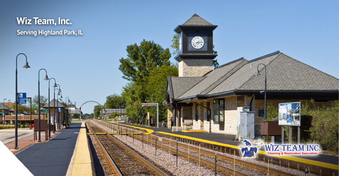 Highland Park train station with clock tower, featuring Wiz Team Inc. branding, serving carpet and upholstery cleaning needs in Highland Park, IL.