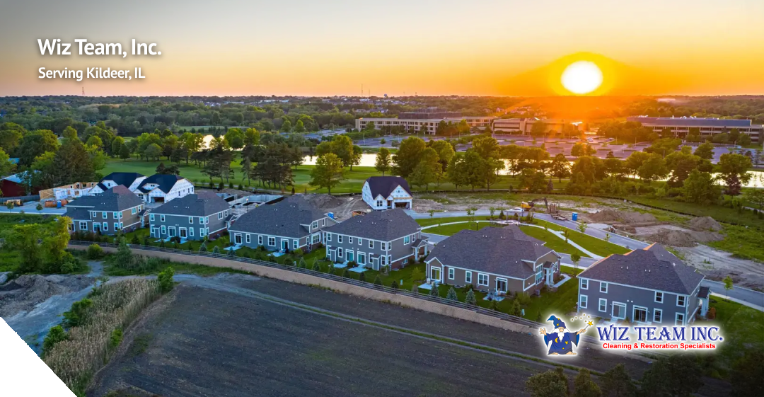 Wiz Team, Inc. logo and text overlay in Kildeer, IL, showcasing a sunset over custom homes and lush greenery in a picturesque suburban setting.