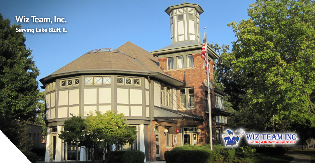 Wiz Team, Inc. building in Lake Bluff, IL, featuring historic architecture, surrounded by greenery, with company logo and text highlighting cleaning services.