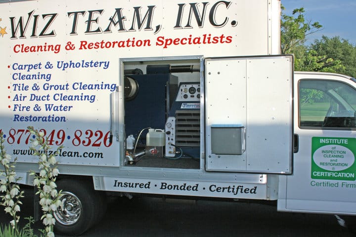 Wiz Team, Inc. service truck showcasing carpet cleaning and restoration equipment, emphasizing professional cleaning services for carpets, upholstery, and air ducts.