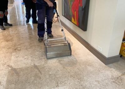 Professional tile and grout cleaning service in action, showcasing advanced steam cleaning equipment on a polished floor in a residential setting.