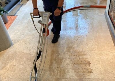 Professional technician using advanced steam cleaning equipment on tile floor, demonstrating Wiz Team, Inc.'s tile and grout cleaning services in Lake Forest area.