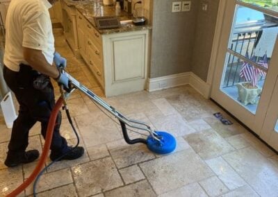Professional technician using advanced steam cleaning equipment on tile floor, showcasing effective tile and grout cleaning services by Wiz Team, Inc.