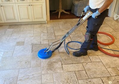 Professional technician using advanced steam cleaning equipment on tile floor for effective tile and grout cleaning service by Wiz Team, Inc.