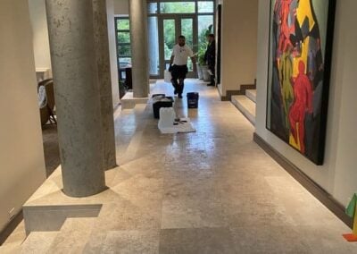 Professional tile and grout cleaning in a modern home, featuring a technician, cleaning supplies, and polished tile flooring, highlighting Wiz Team, Inc.'s services.