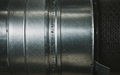 Close-up of a metallic duct with moisture droplets, relevant to winter indoor air quality and duct cleaning services in Lake Forest, IL.