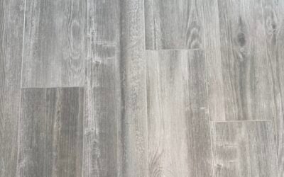 After restoration, revitalized light gray wood-like flooring showcasing a clean and polished surface, emphasizing the transformation achieved by Wiz Team Inc.