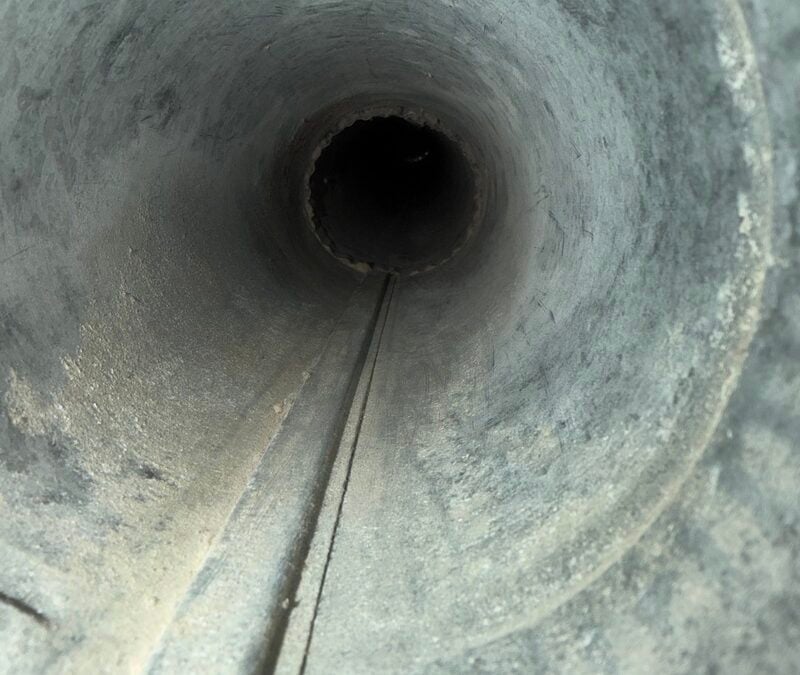 Air duct interior showing buildup before cleaning, highlighting air duct and dryer vent purification services by Wiz Team Inc. in Deer Park, Illinois.